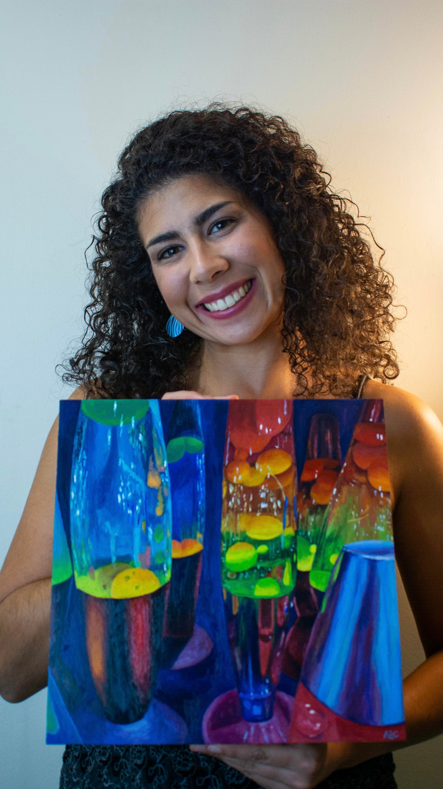 Artist holding lava lamps painting