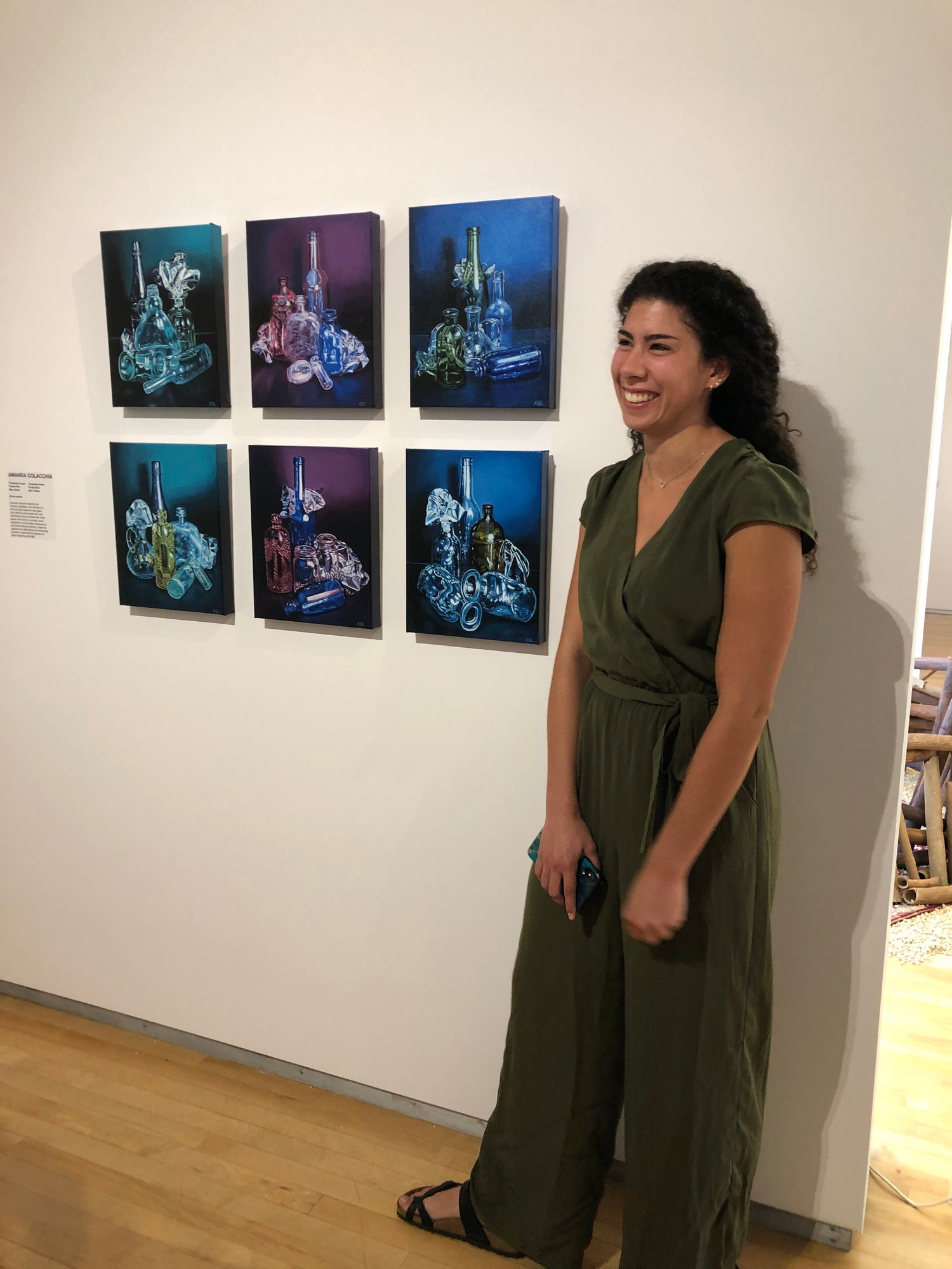 Artist with college senior project paintings